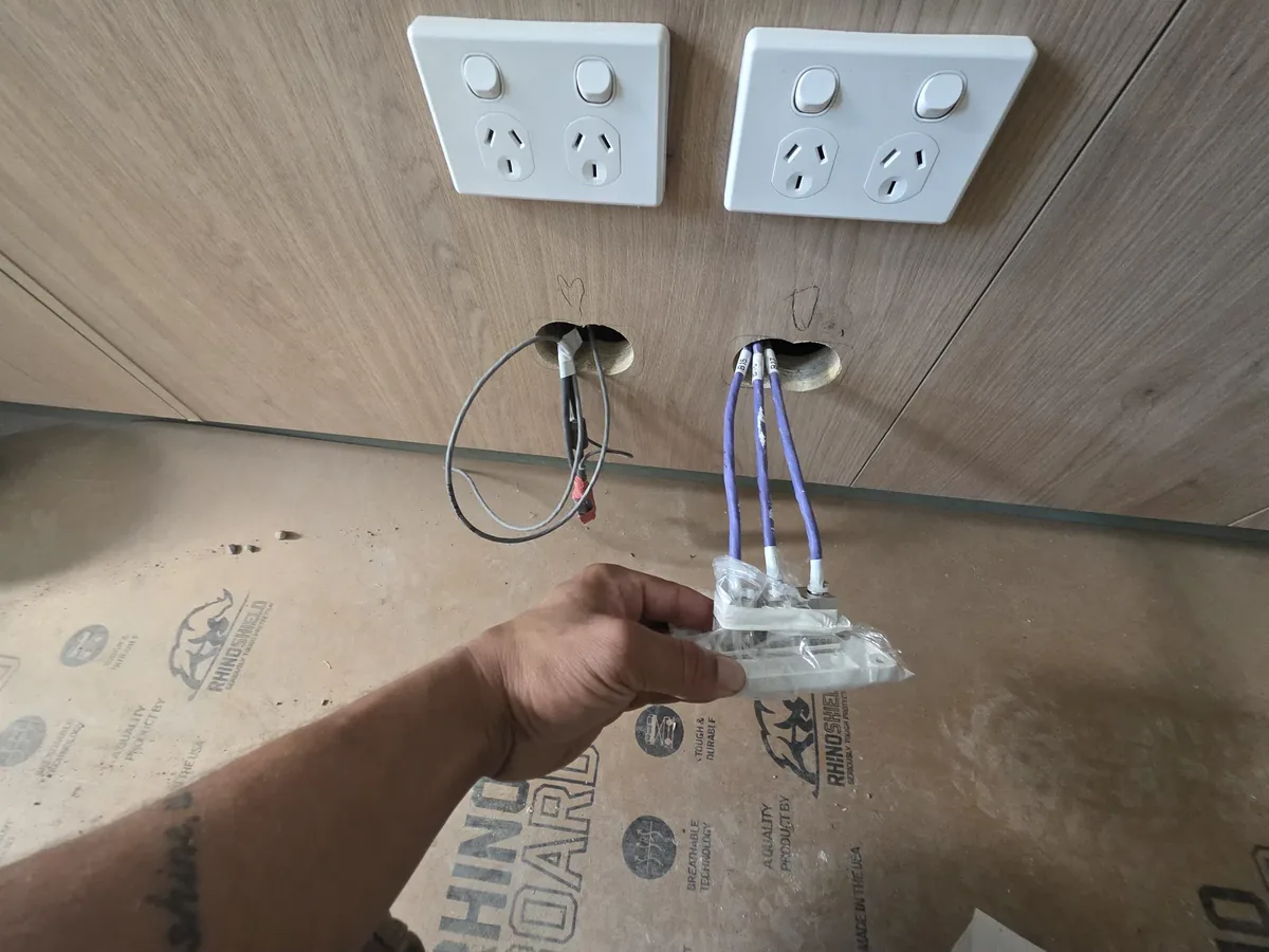 Cat6 data cabling terminated at a wall outlet during a Brisbane installation