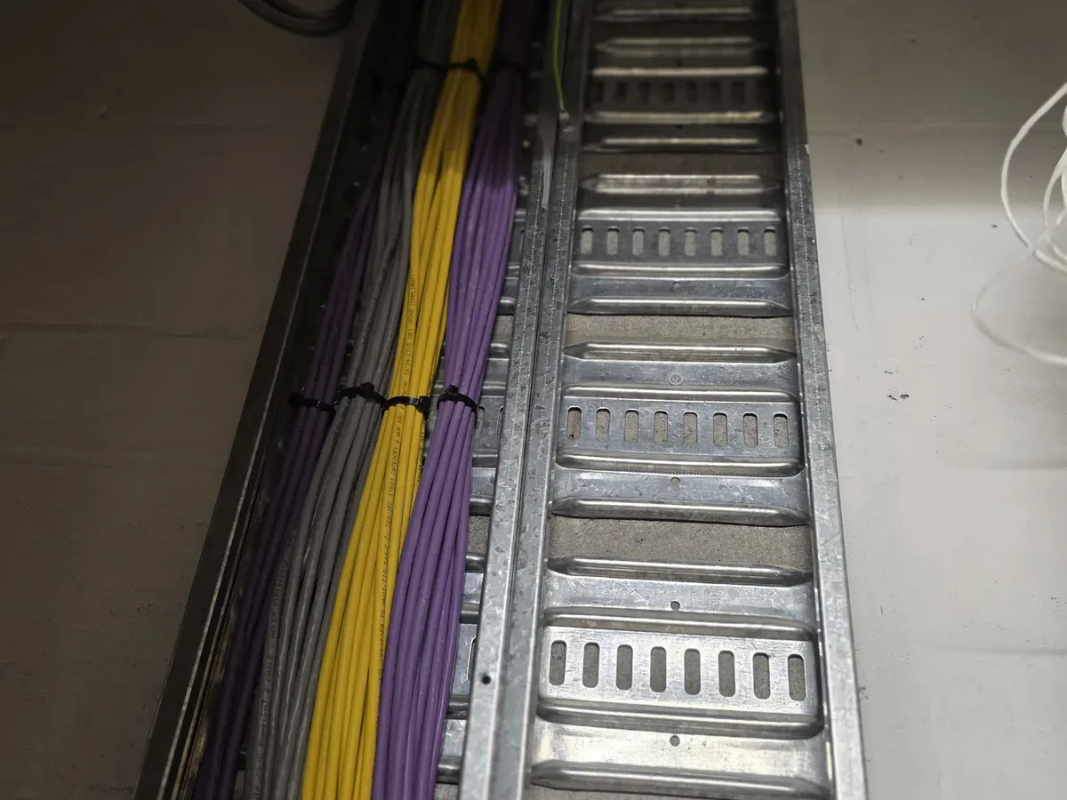 Structured network cabling bundled along a cable tray in a commercial building