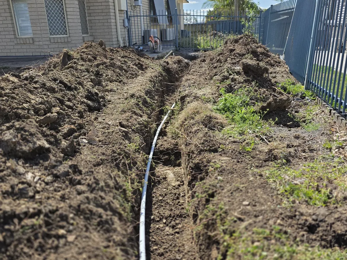 Underground telecommunications conduit laid in an open trench