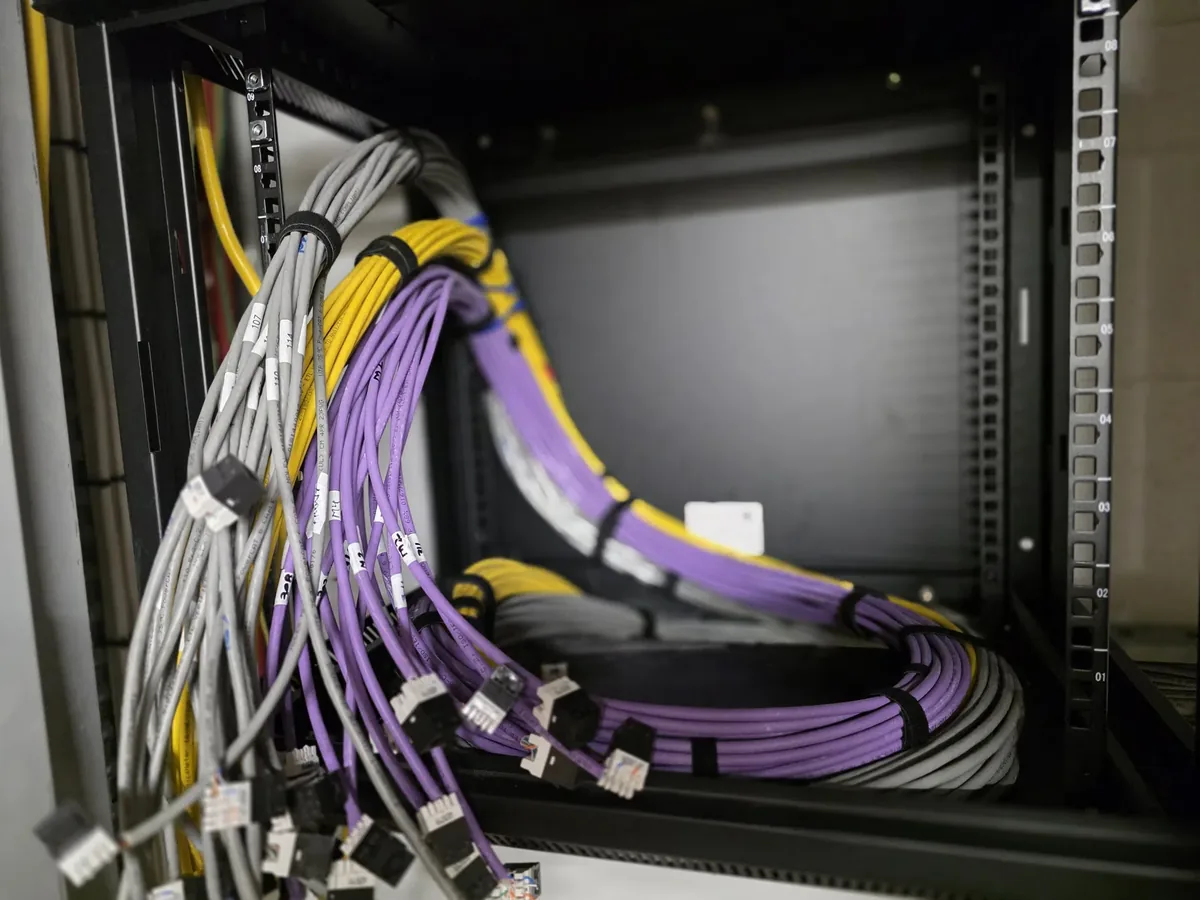 Network rack with patch panels and cable management in a commercial comms room